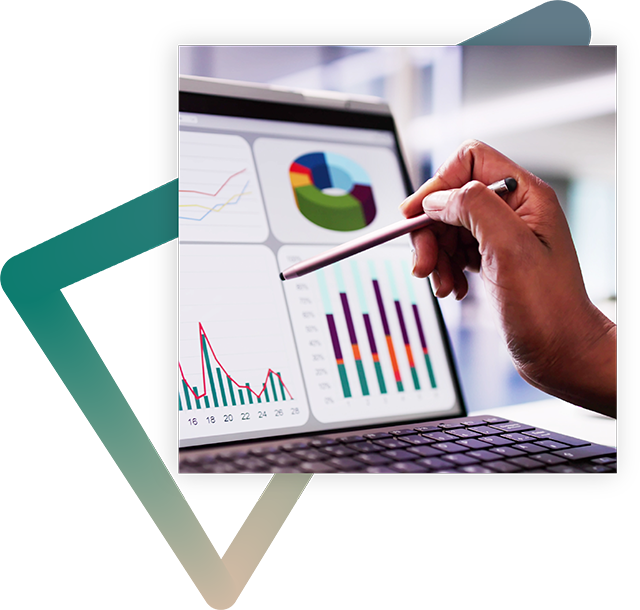Close-up of a person's hand holding a stylus, pointing to data displayed on a computer screen.
