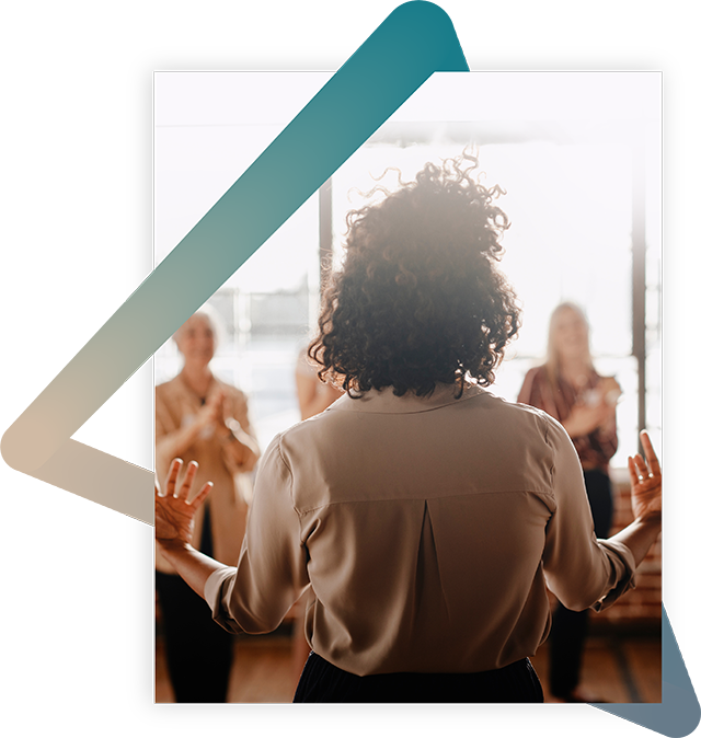 Person speaking to a group of people.